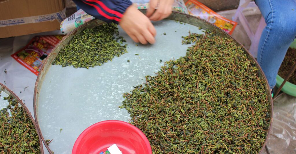 a large round dish with tea being sorted