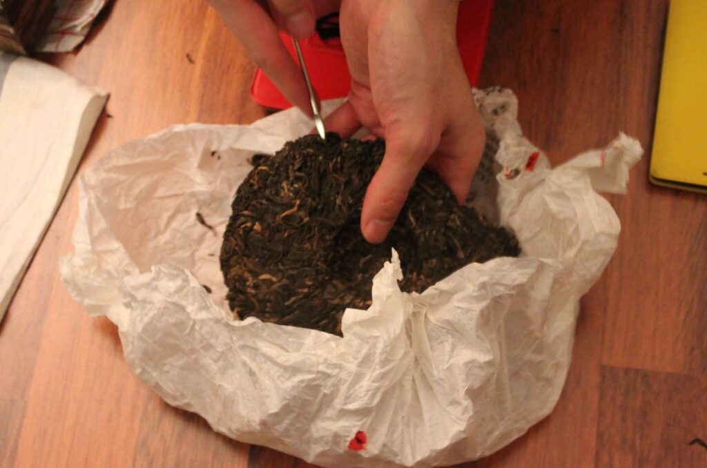 chipping away at pu'er tea cake