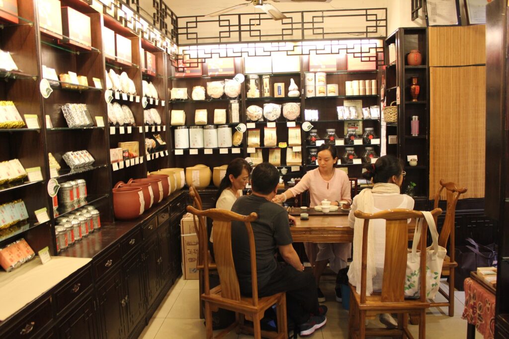 4 people sat at a table in a tea shop