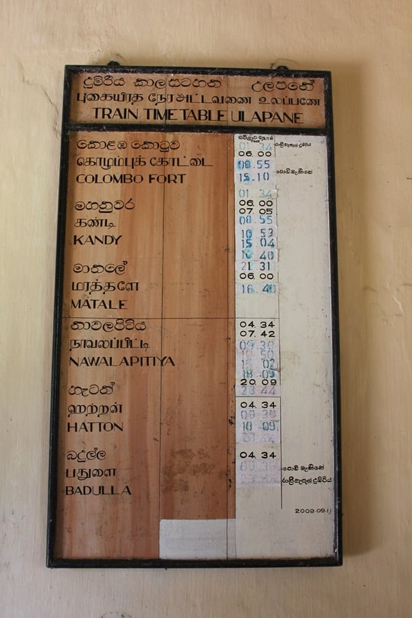Train timetable sign made of wood at Ullapane train station in Sri Lanka
