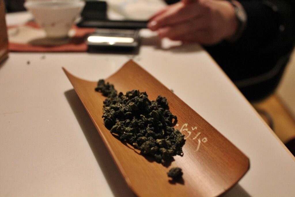 dry tea leaves on wooden scoop