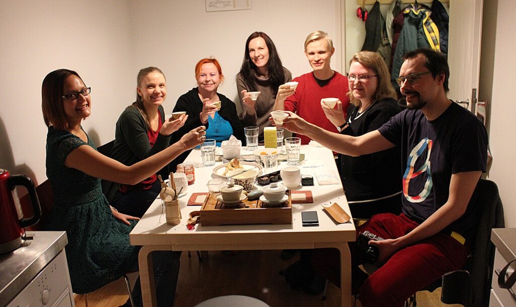 helsinki tea tasters group group of 7 people sitting around dining table drinking tea