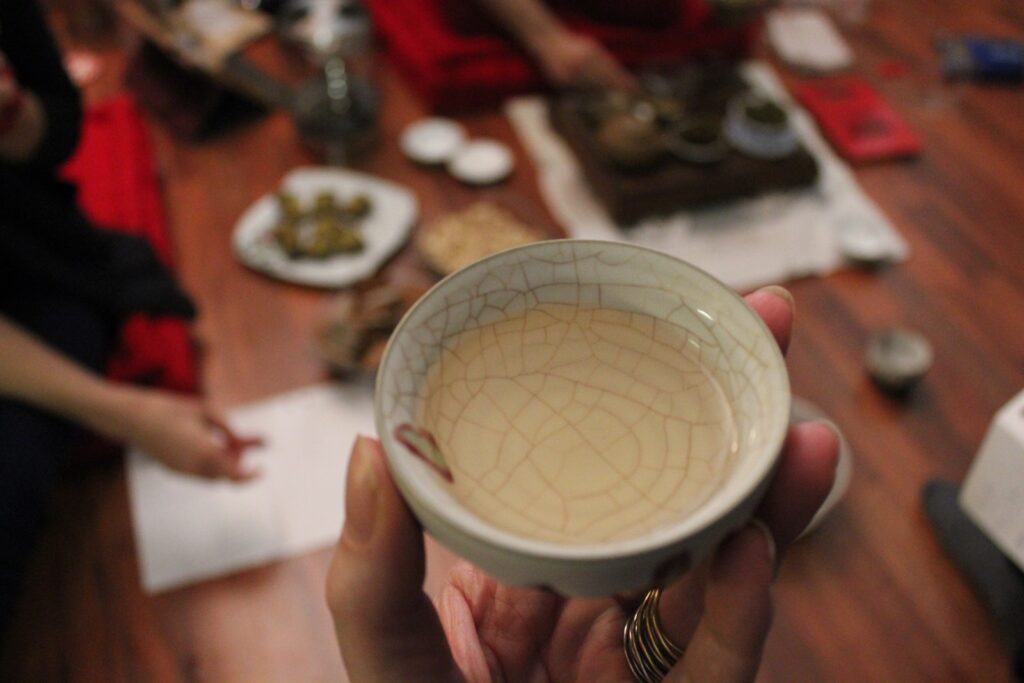 Autumn Ban Po tea liquor in a tea cup being held by a hand