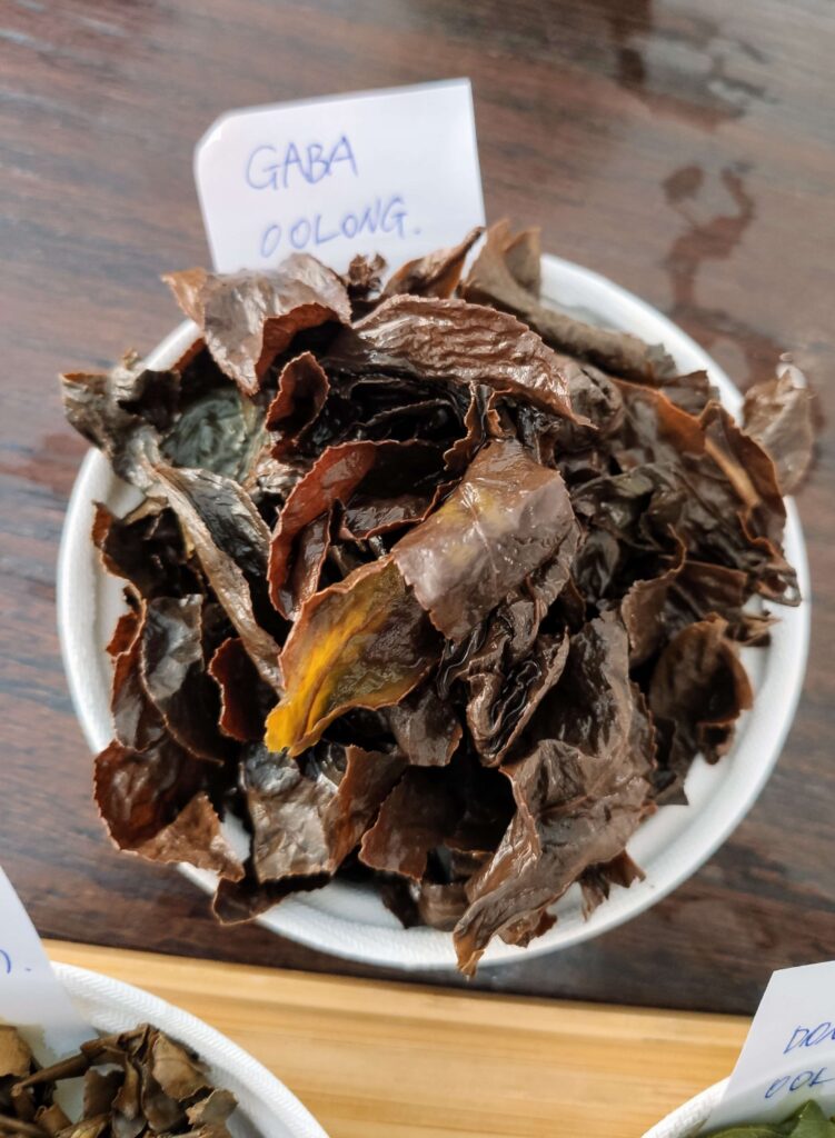wet tea leaves on white plate