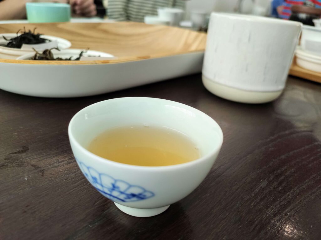 white tea cup containing tea liquor