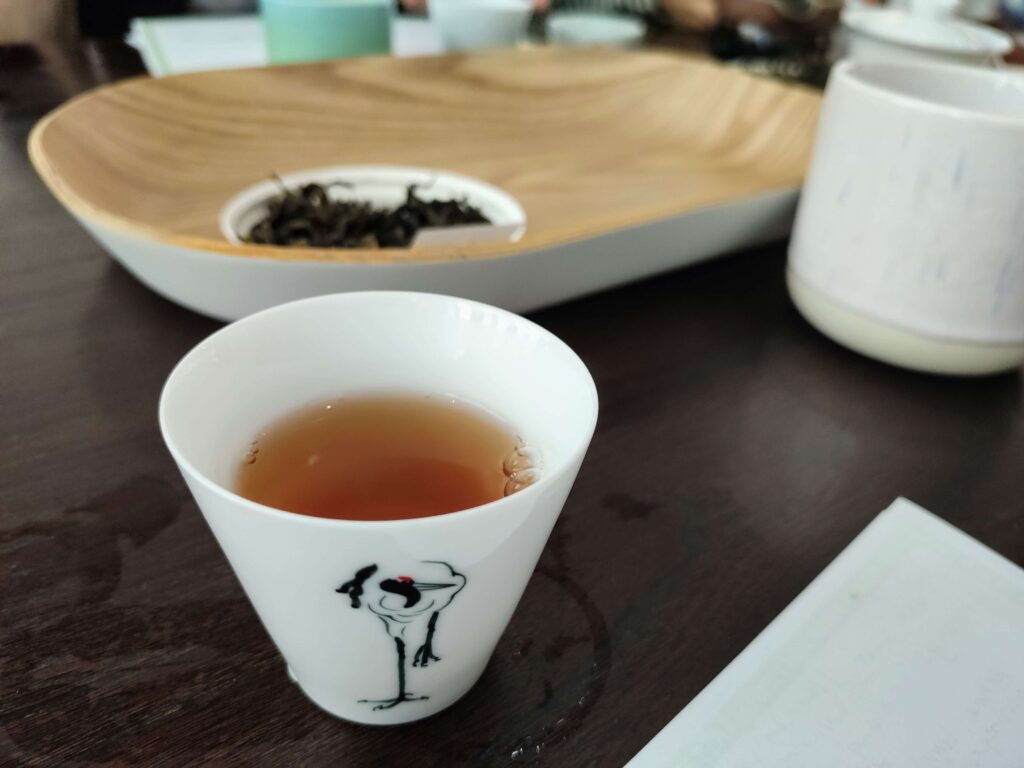white tea cup containing tea liquor