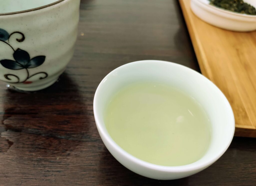 pale oolong tea liquor in white tea cup