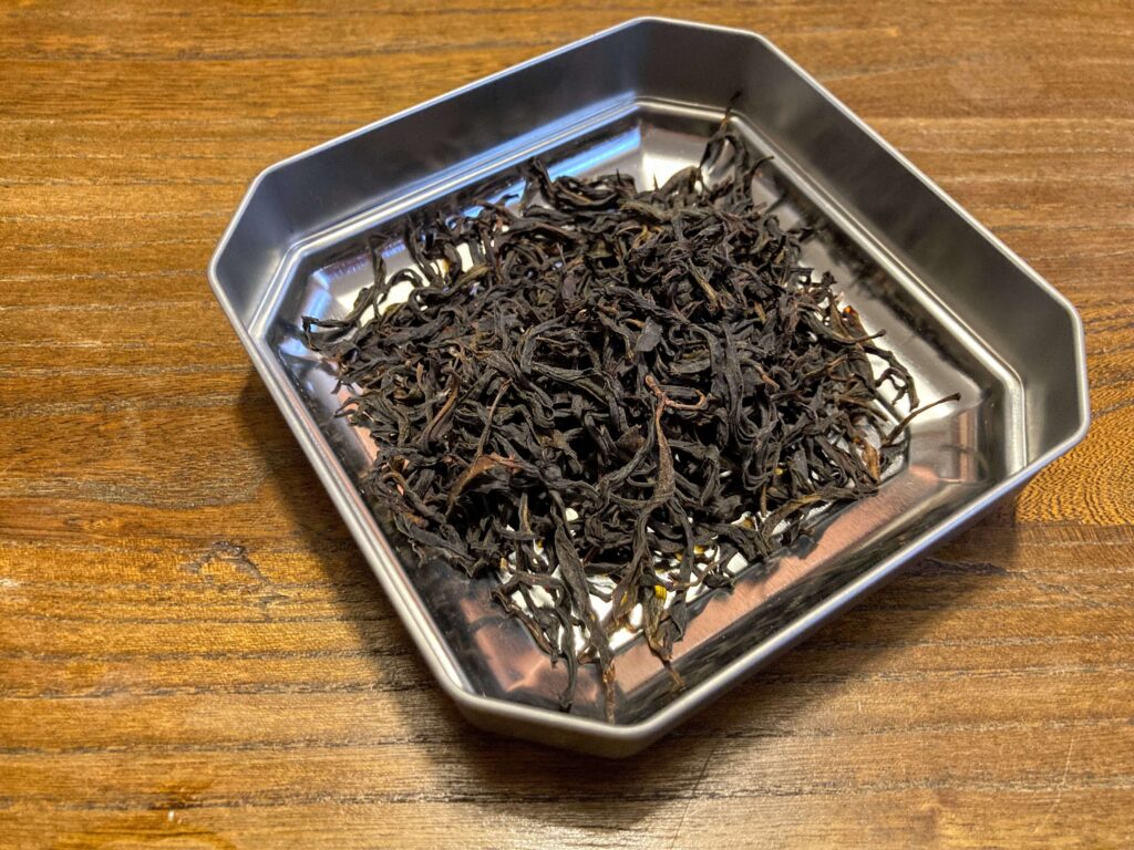 Dry tea leaves in tin lid