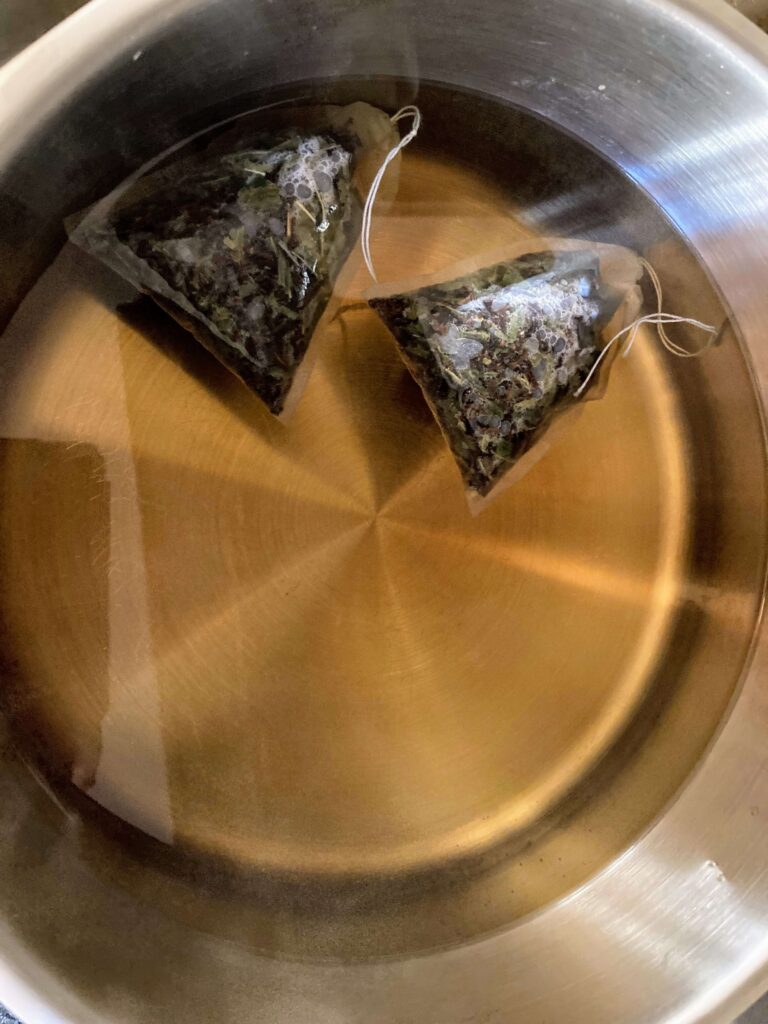 tea bags brewing in a pan