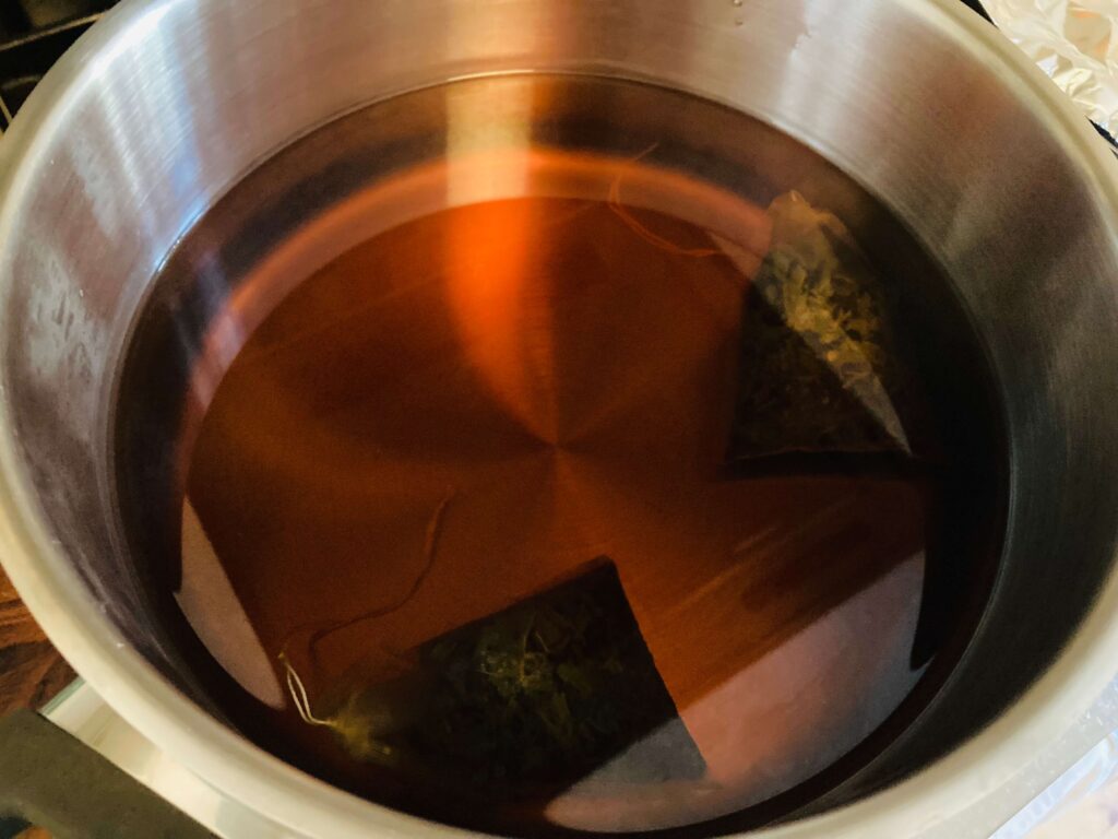 tea bags brewing in a pan