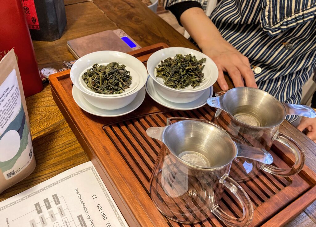Takachiho brewing Gongfu tea preparation on a tea tray with wet tea leaves