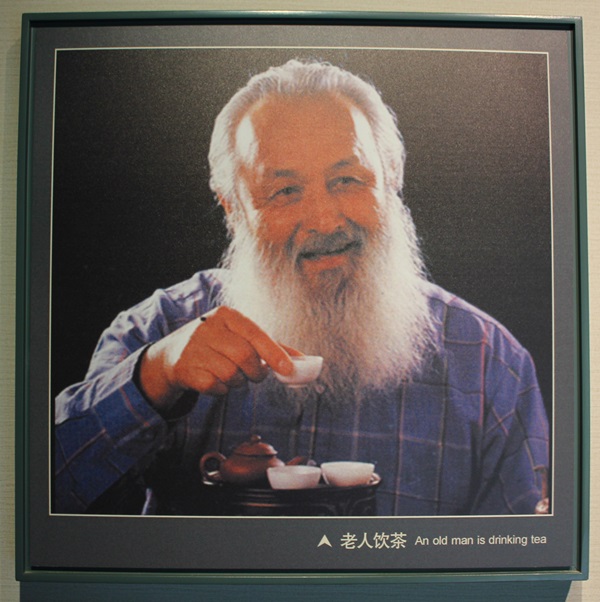 an old man drinking tea