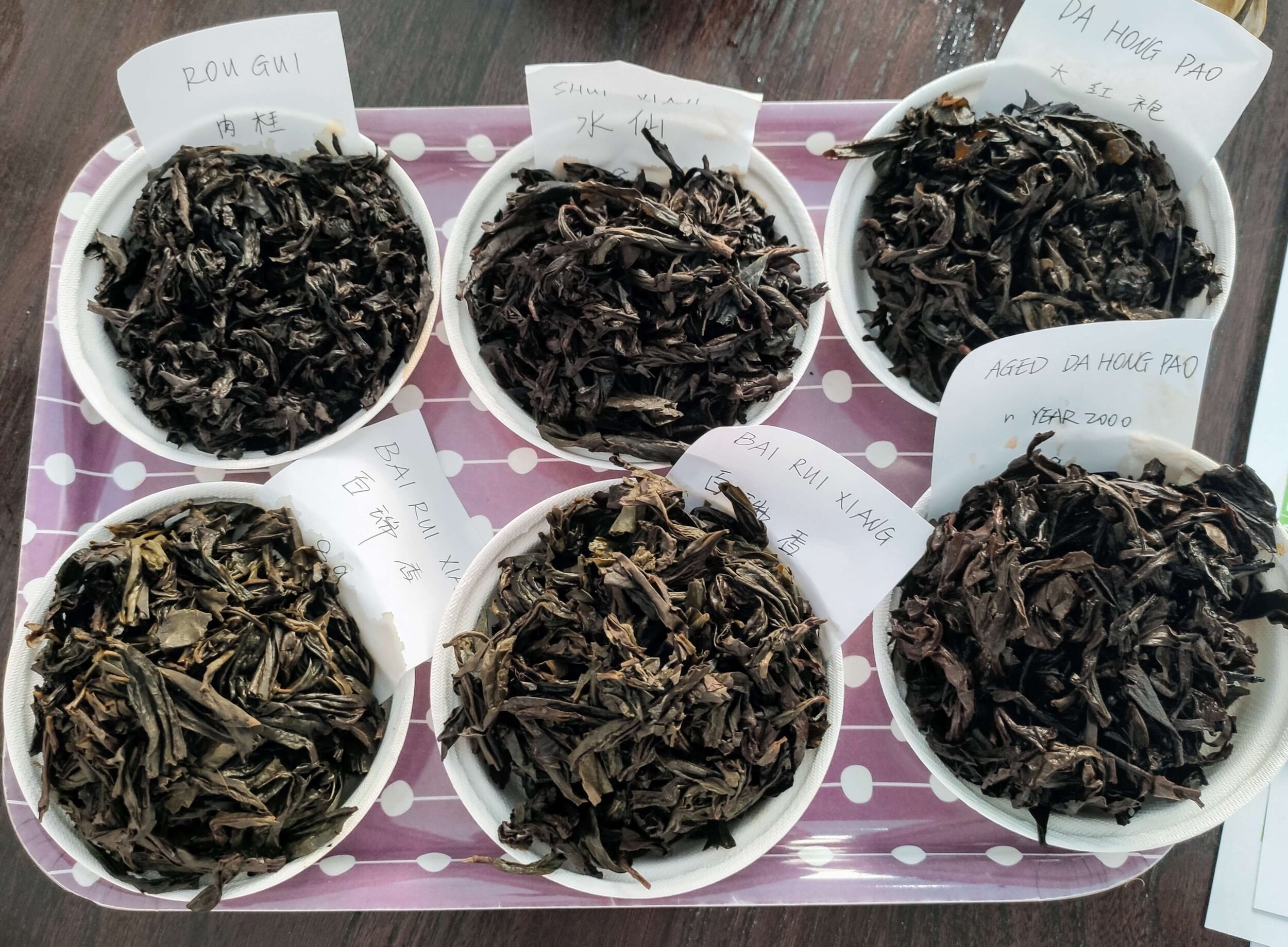Wet leaves: top row, left to right - Rou Gui, Shui Xian, Da Hong Pao; bottom row, left to right - Bai Rui Xiang x 2, Aged Da Hong Pao