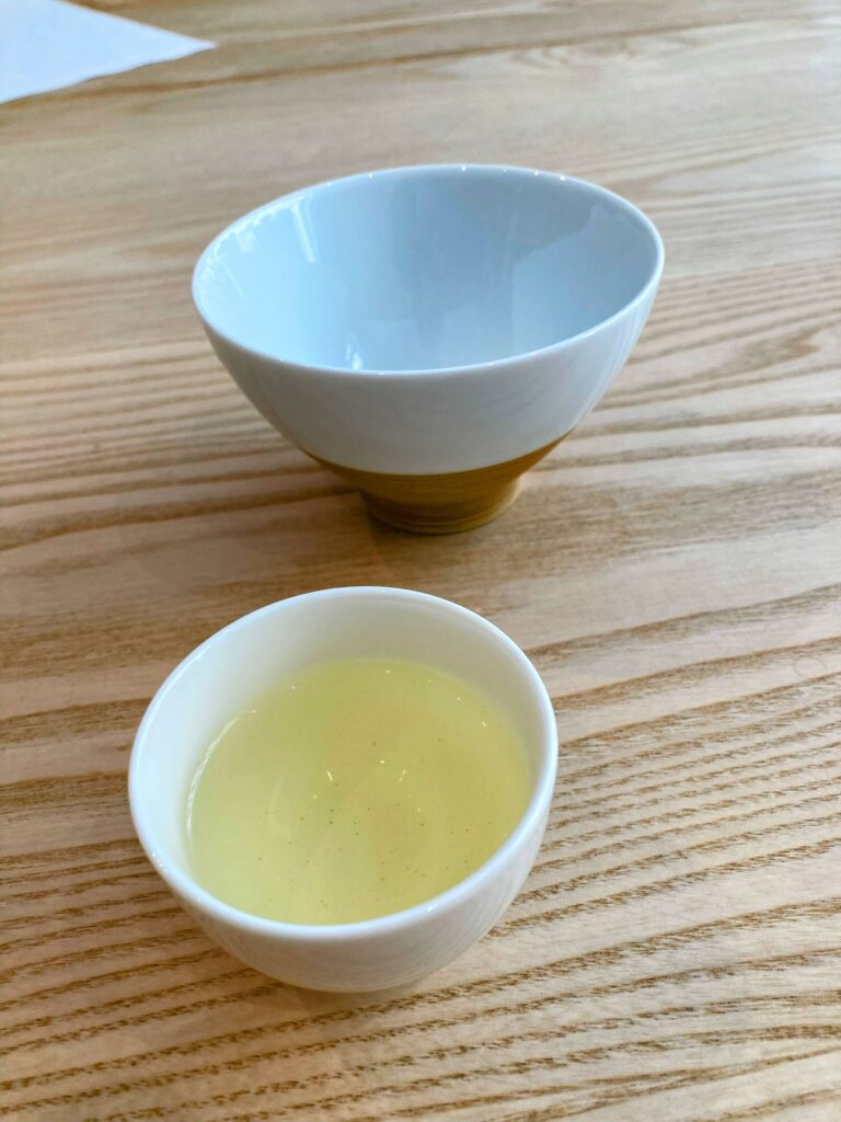 green tea liquor in white cup