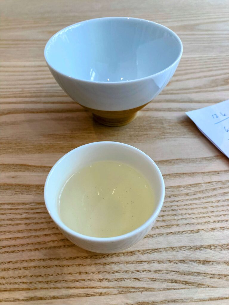 green tea liquor in white cup