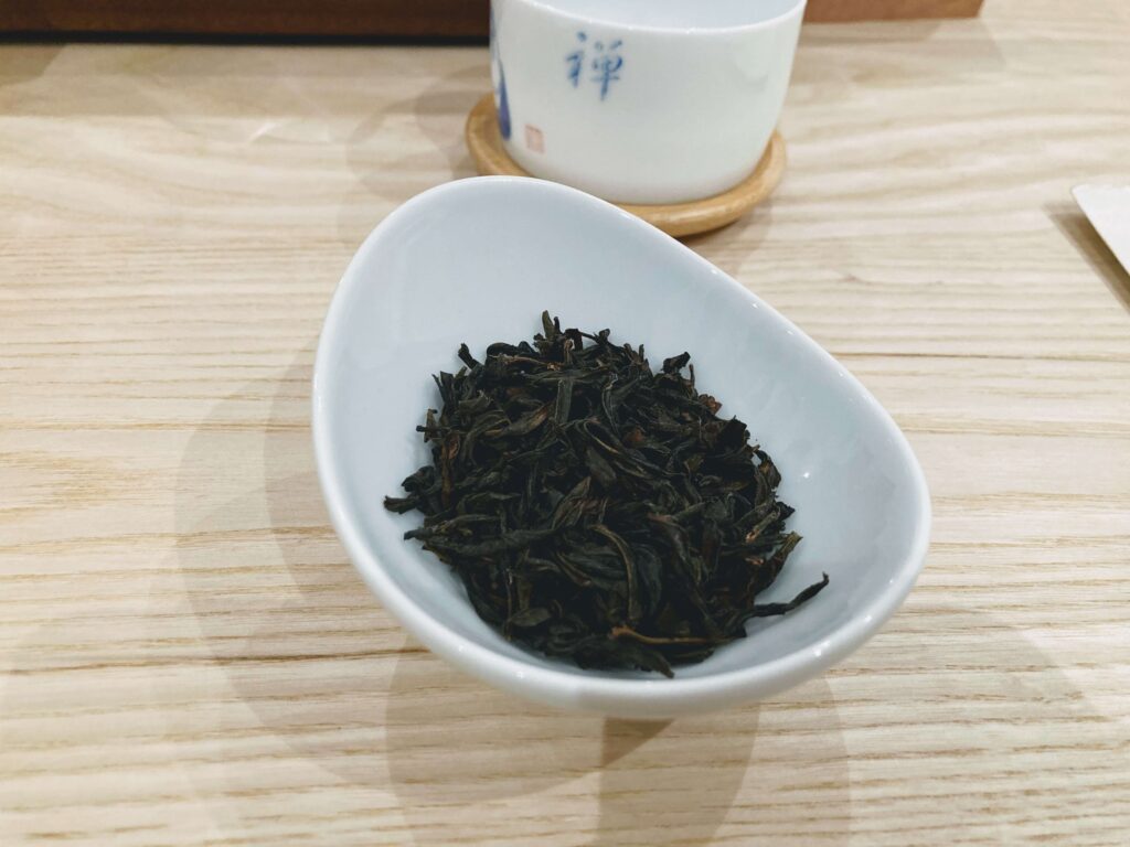 song zhong oolong dry tea leaves in white bowl