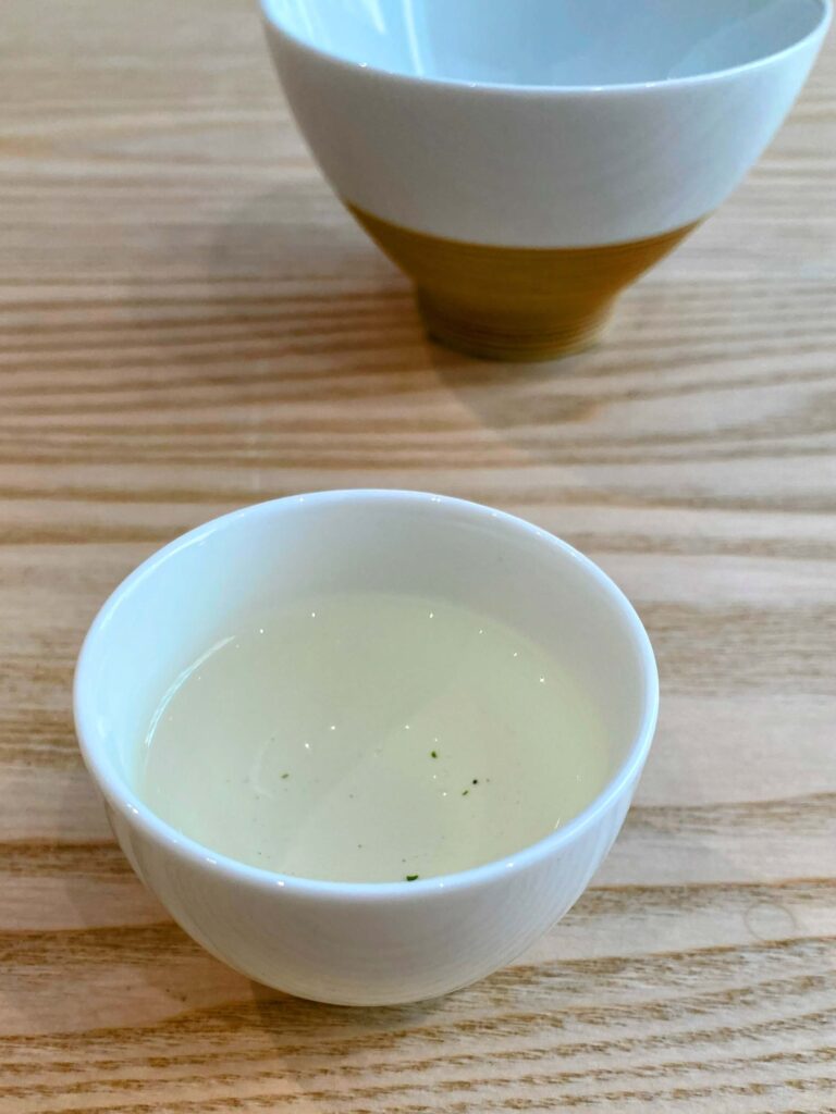 green tea liquor in white cup