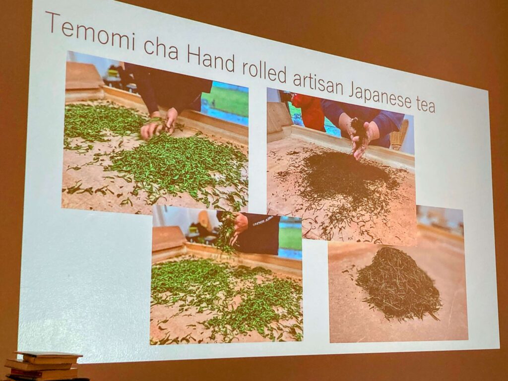 A presentation slide titled Temomi cha Hand rolled artisan Japanese tea with four photos showing hands rolling and processing Sayama Sencha green tea leaves at different stages.